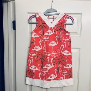 Pink flamingo cotton dress with scallop details.